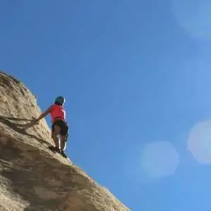An amazing photo of a person in action of mounting climbing.