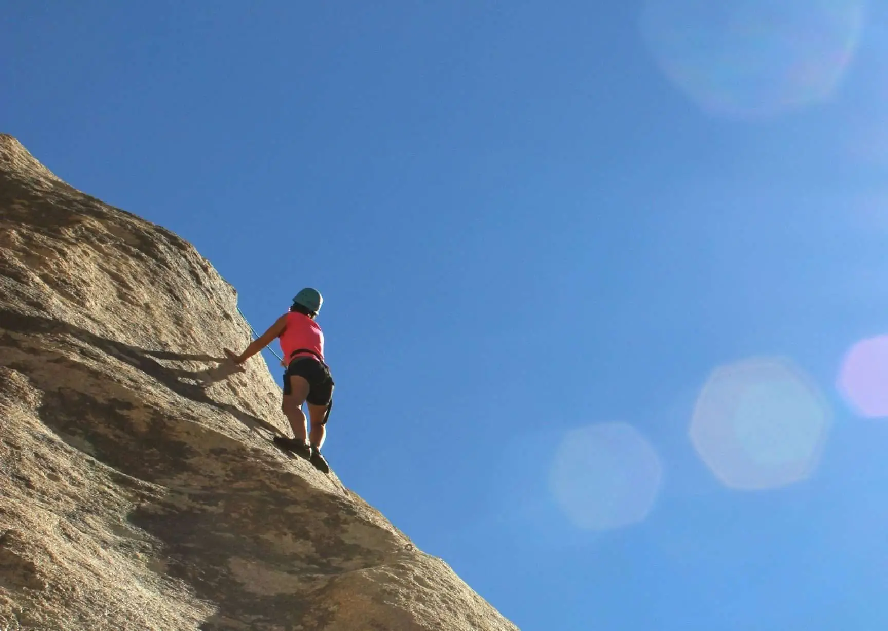 An amazing photo of a person in action of mounting climbing.